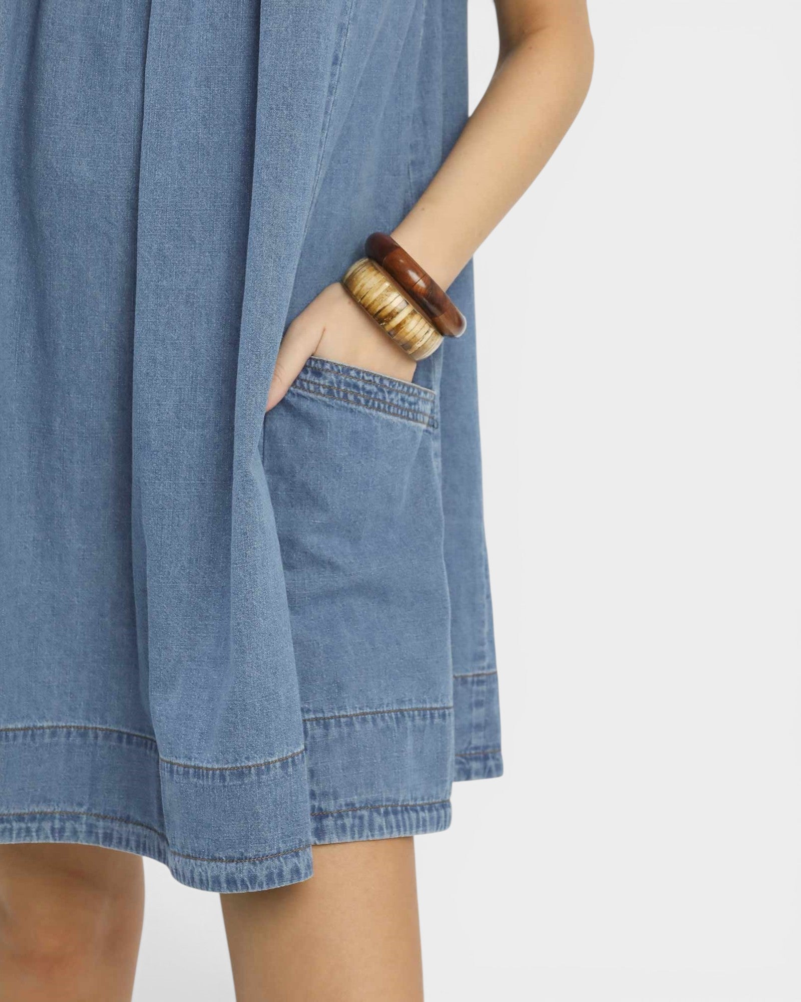 Blue denim dress with a plain background