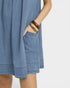 Blue denim dress with a plain background