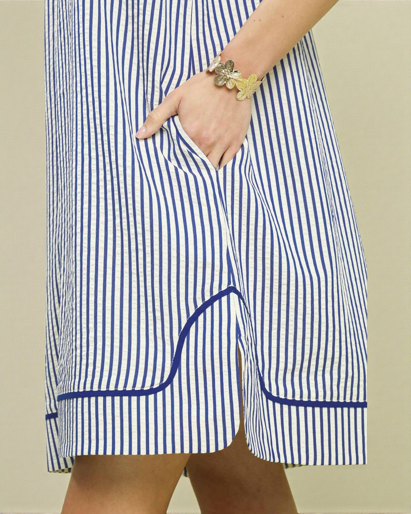 Blue and white striped shorts with a pocket on a neutral background