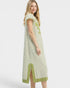 Woman wearing a green and white striped dress on a white background