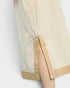 Close-up of a beige and white striped shirt with a plain background