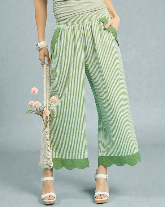 Green checkered pants worn by a person on a gray background