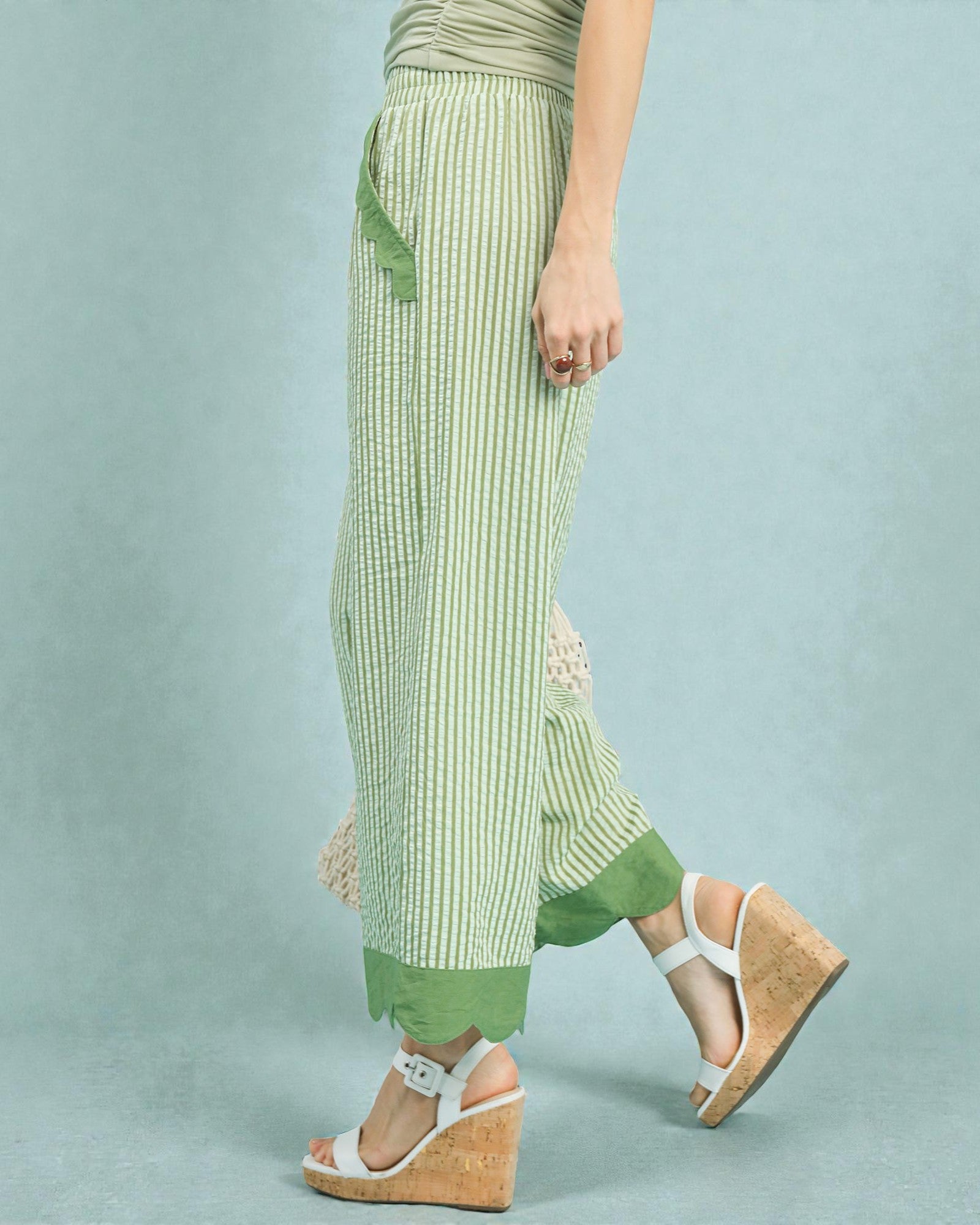 Green and white striped pants with a plain background