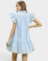 Woman wearing a light blue dress with ruffled sleeves on a white background