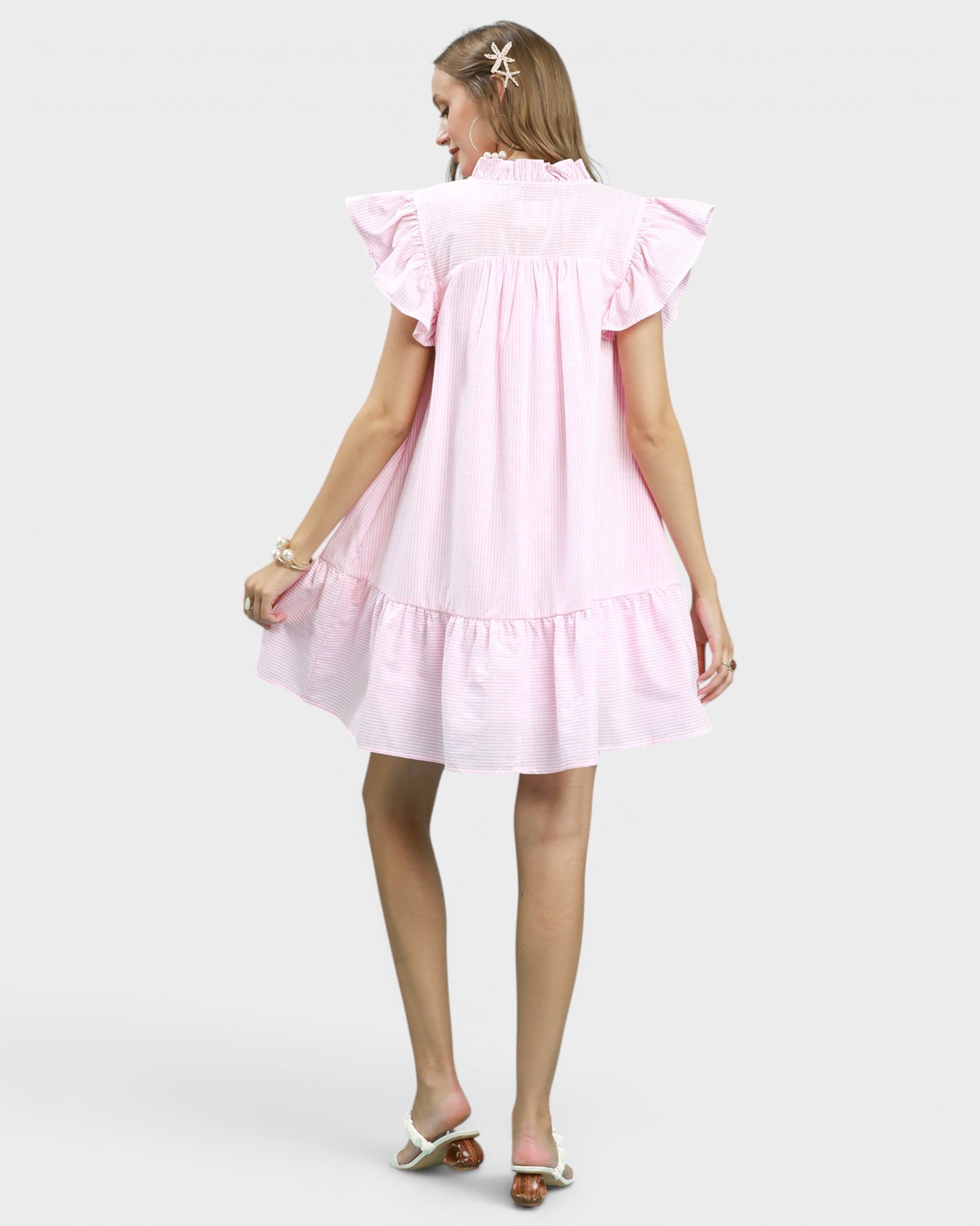 Woman wearing a pink dress on a white background