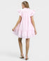 Woman wearing a pink dress on a white background