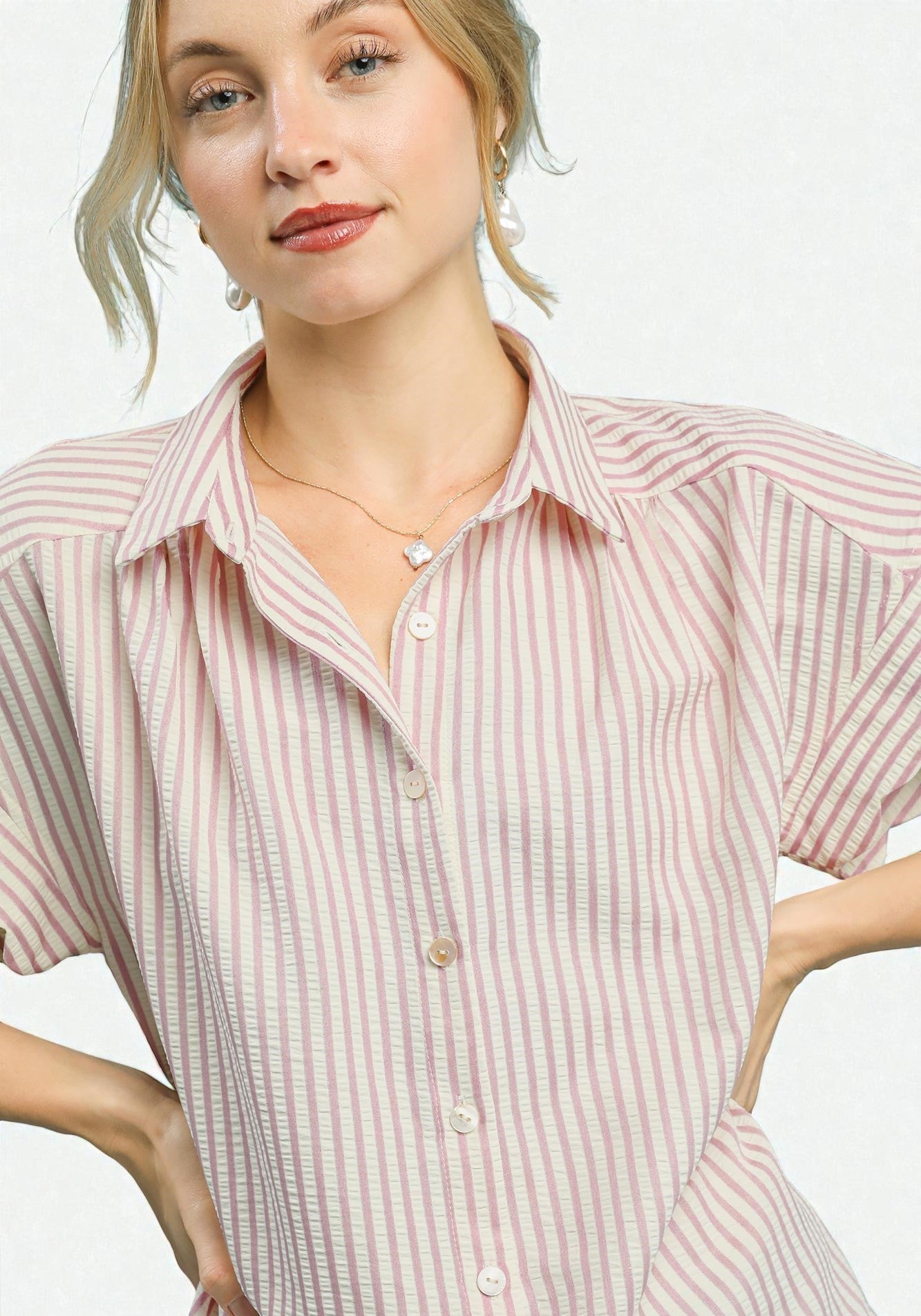 Woman wearing a pink and white striped shirt on a white background