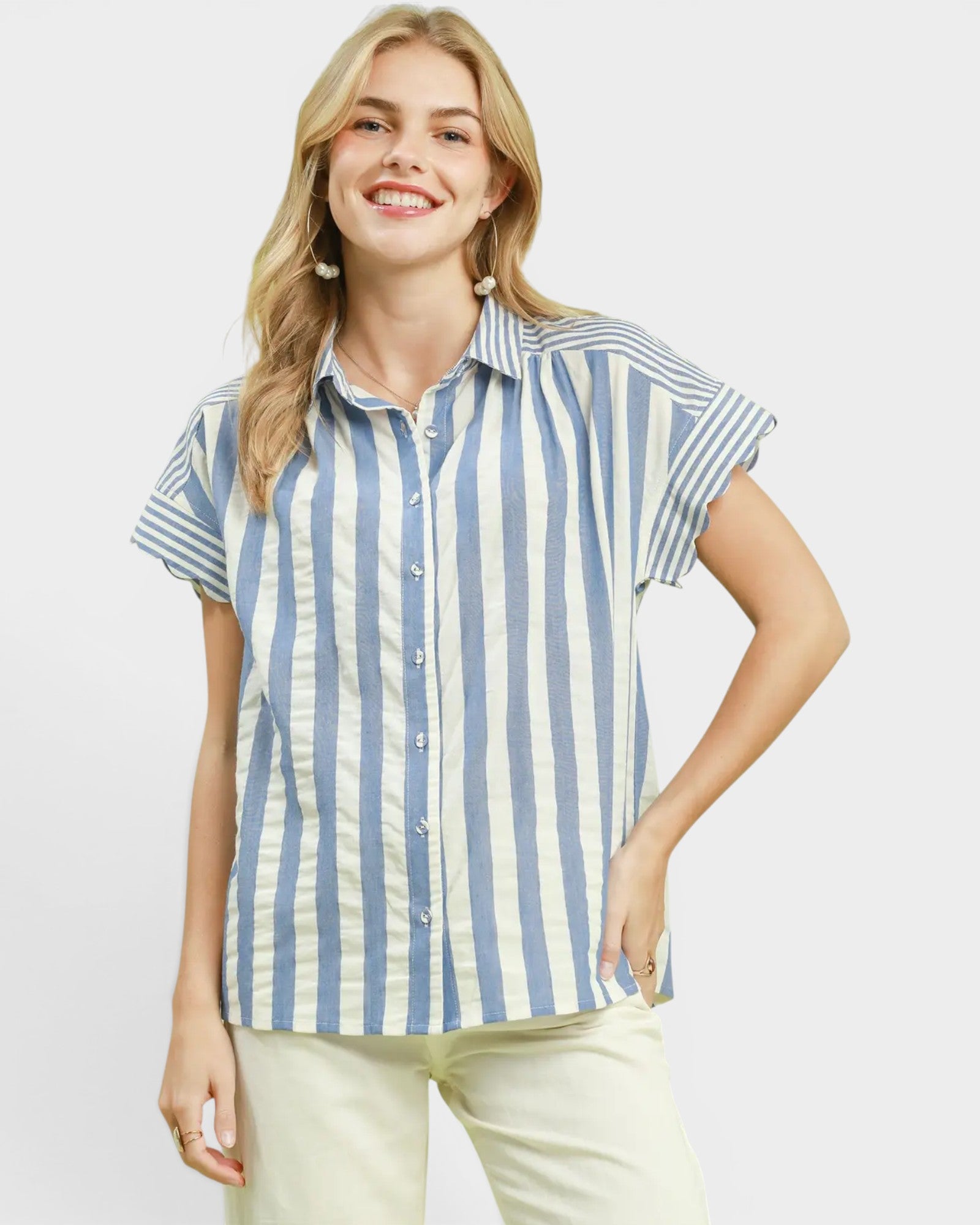 Woman wearing a blue and white striped shirt on a plain background