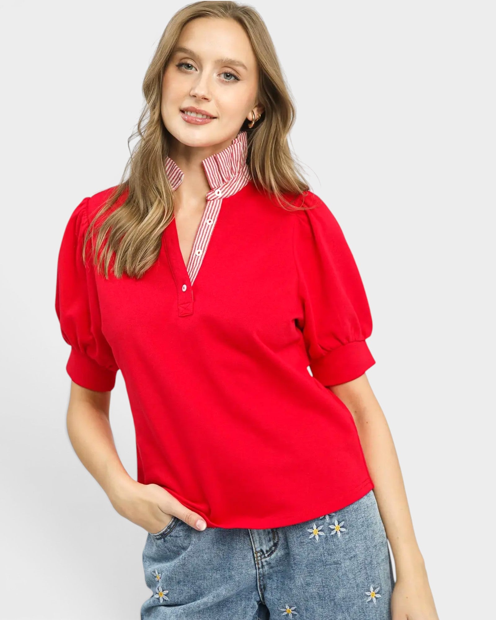 Woman wearing a red blouse with a white background