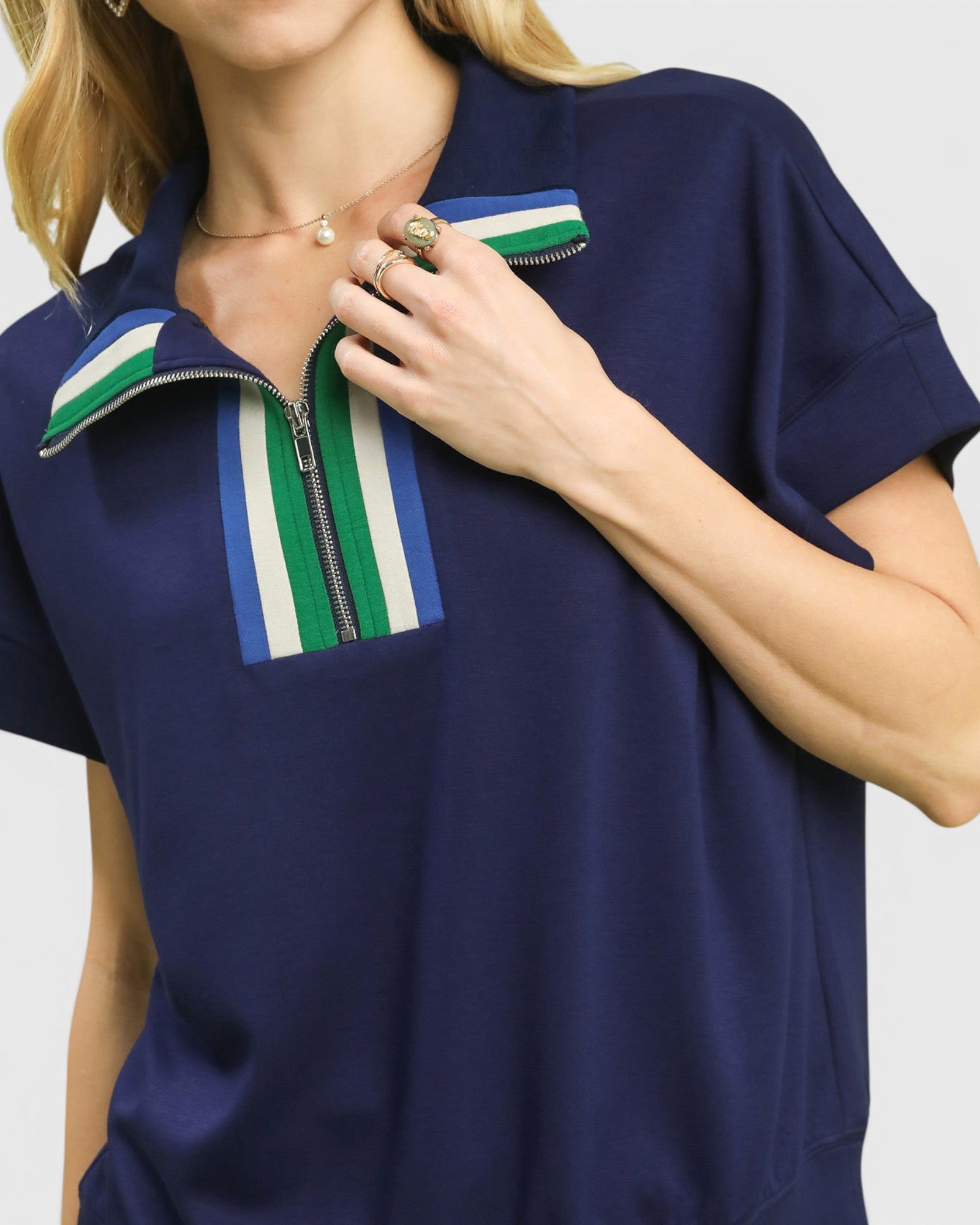 Navy blue shirt with a colorful zipper detail worn by a person