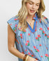 Woman wearing a blue floral blouse with a white background