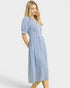 Woman wearing a blue and white striped dress on a white background