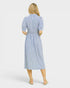 Woman wearing a blue and white striped dress on a white background
