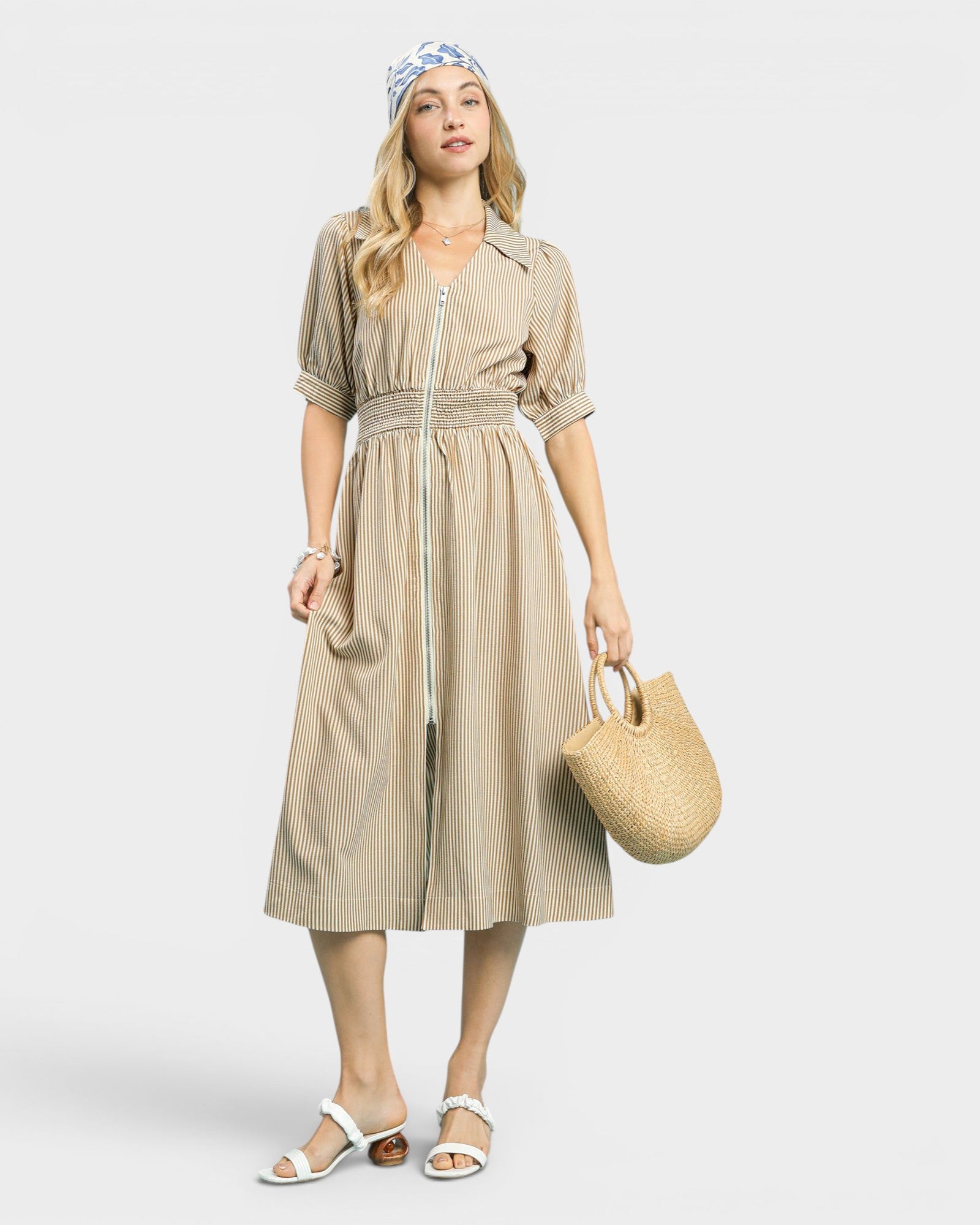 Woman wearing a beige dress with a white background