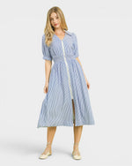 Woman wearing a blue and white striped dress on a white background