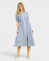 Woman wearing a blue and white striped dress on a white background