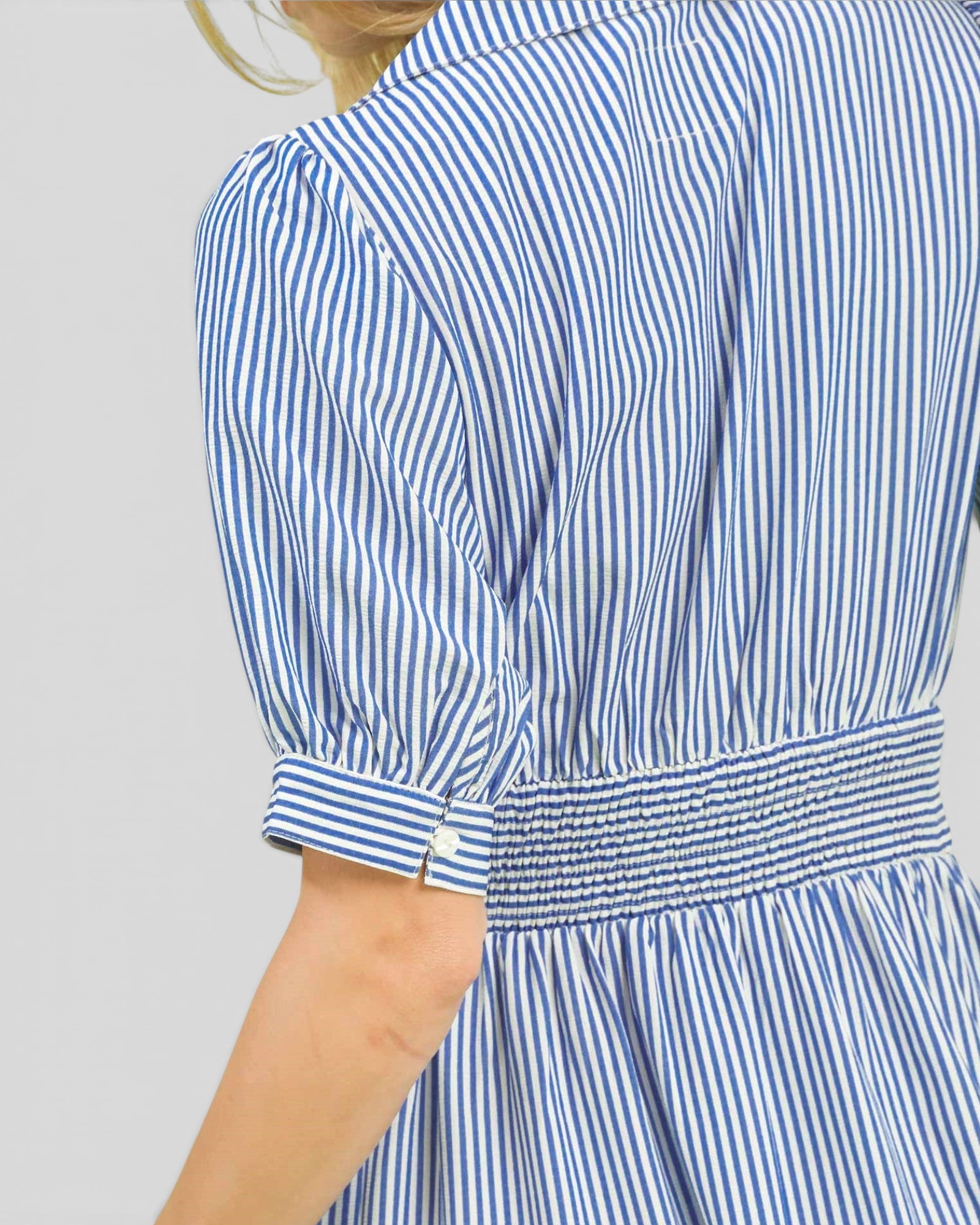 Blue and white striped dress with a plain background