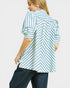 Person wearing a blue and white striped shirt on a plain background