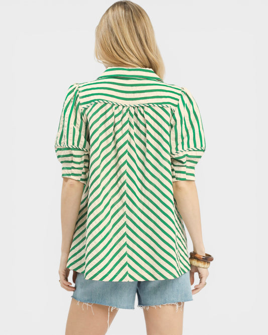 Woman wearing a green and white striped shirt on a white background