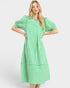 Woman wearing a green and white striped dress on a white background