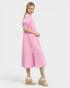 Woman wearing a pink and white striped dress on a white background