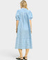 Woman wearing a blue and white striped dress on a white background