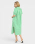 Woman wearing a green and white striped dress on a white background