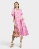 Woman wearing a pink and white striped dress on a white background