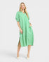 Woman wearing a green and white striped dress on a white background
