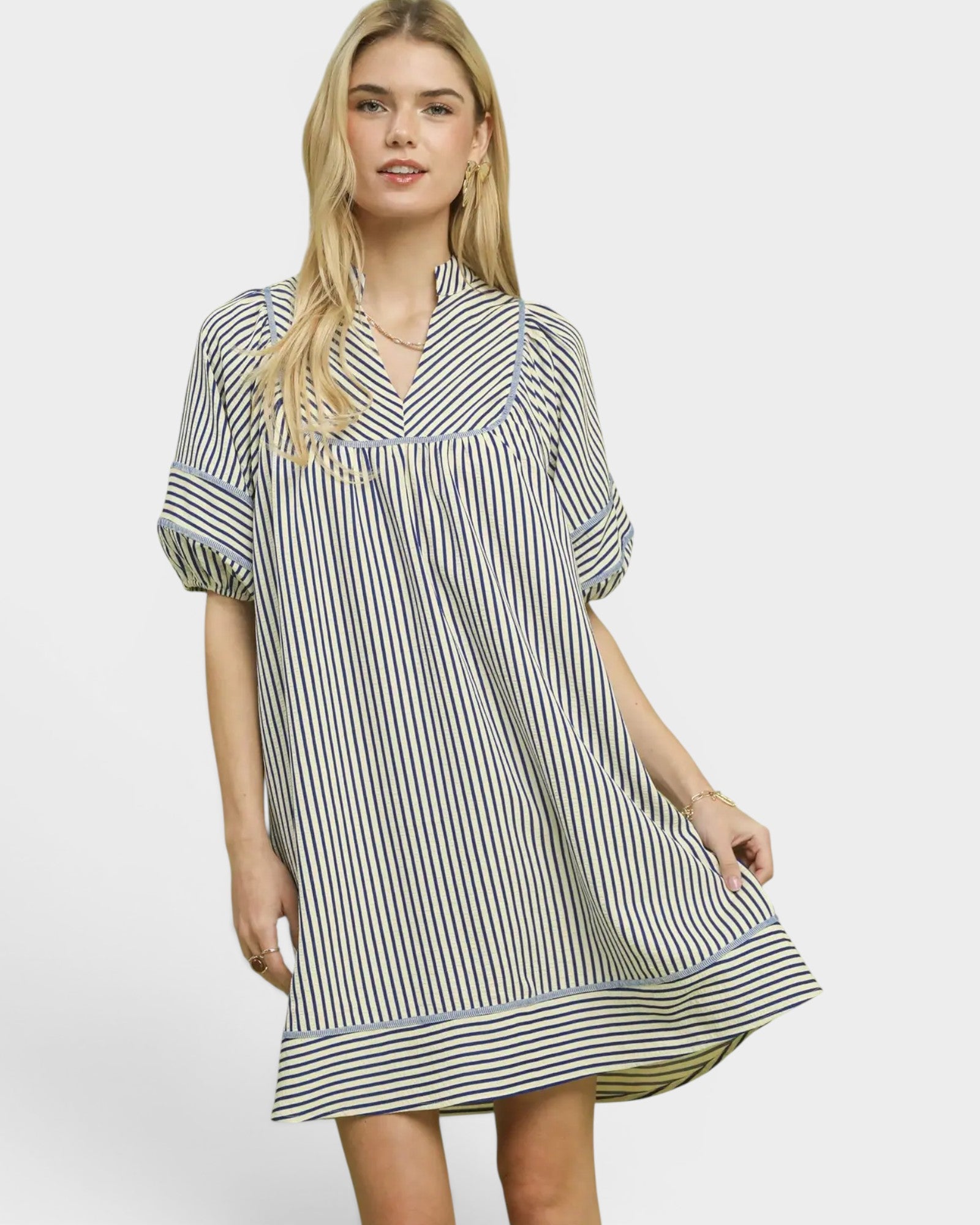 Woman wearing a black and white striped dress on a white background