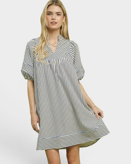 Woman wearing a black and white striped dress on a white background