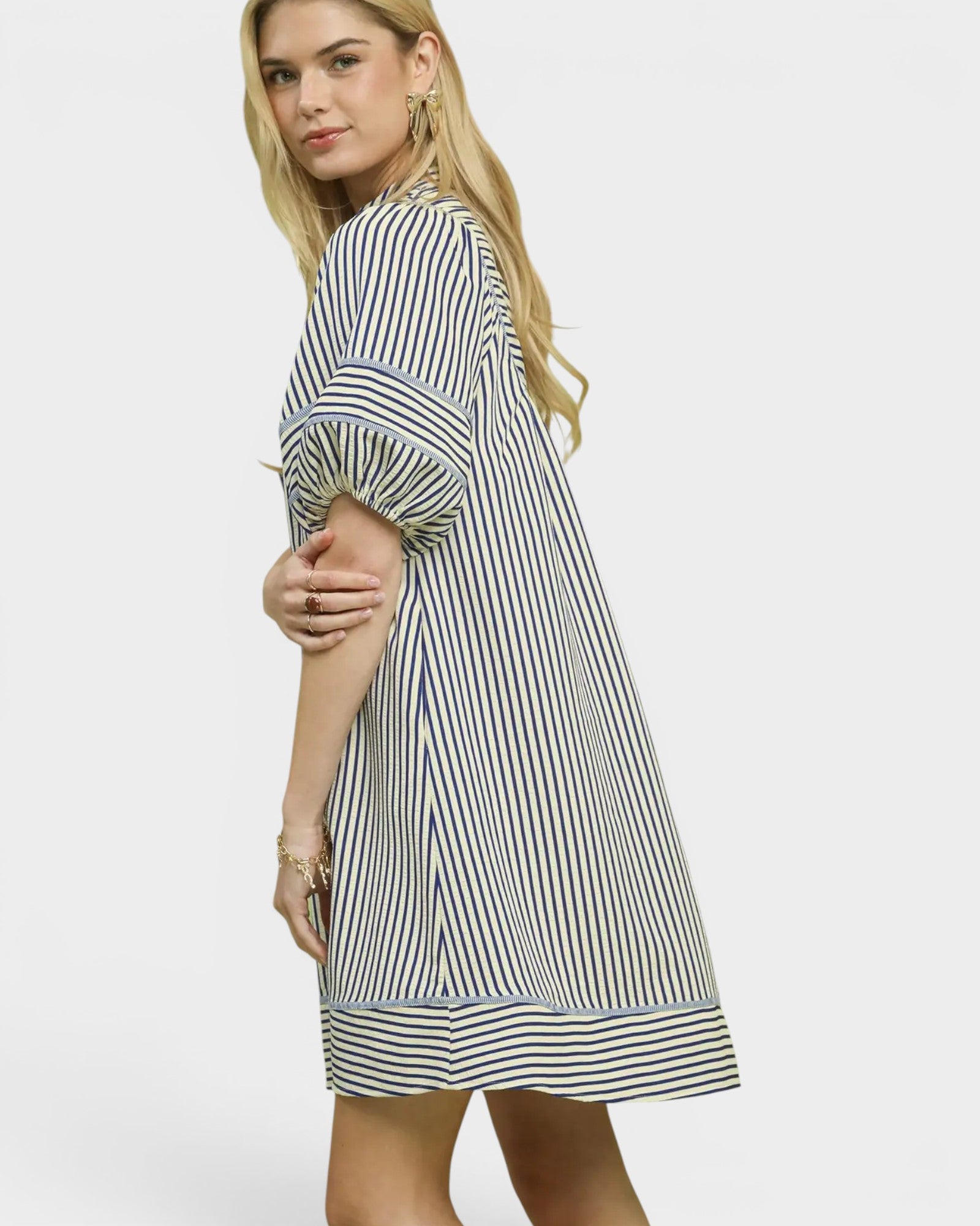 Woman wearing a striped dress on a white background