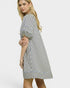 Woman wearing a striped dress on a white background