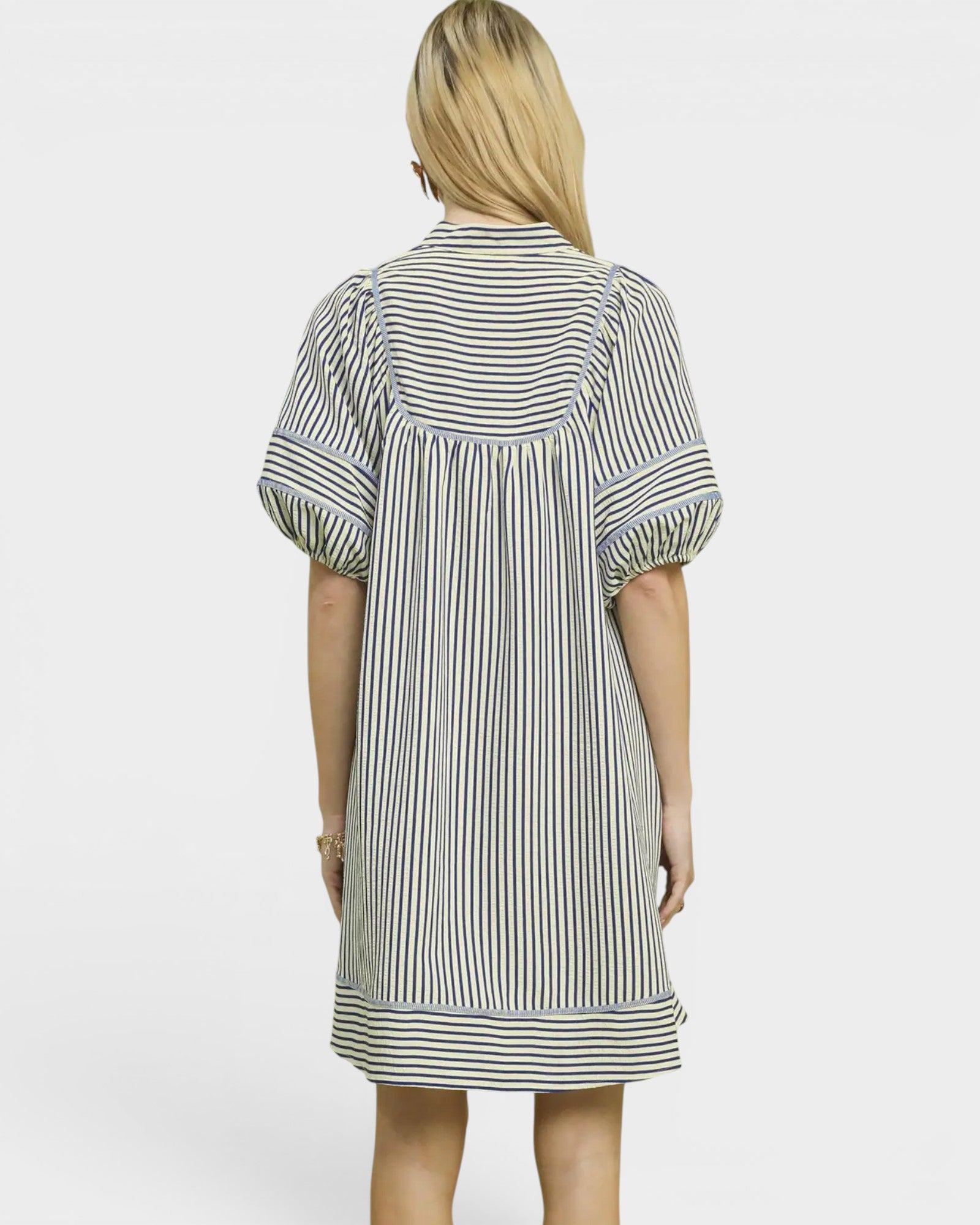 Woman wearing a striped dress on a white background