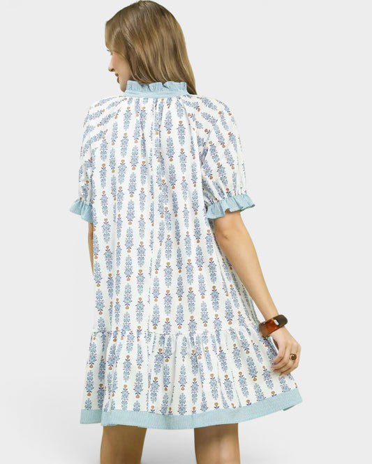 Woman wearing a patterned dress on a white background