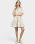 Woman wearing a patterned dress on a white background