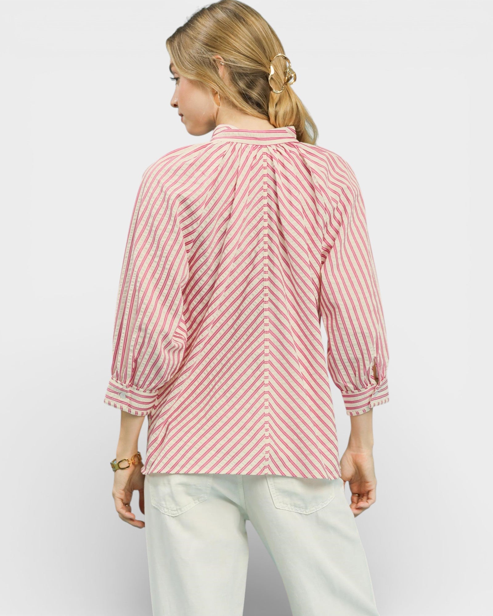 Woman wearing a red and white striped shirt on a plain background