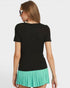 Woman wearing a black top and green pleated skirt on a white background