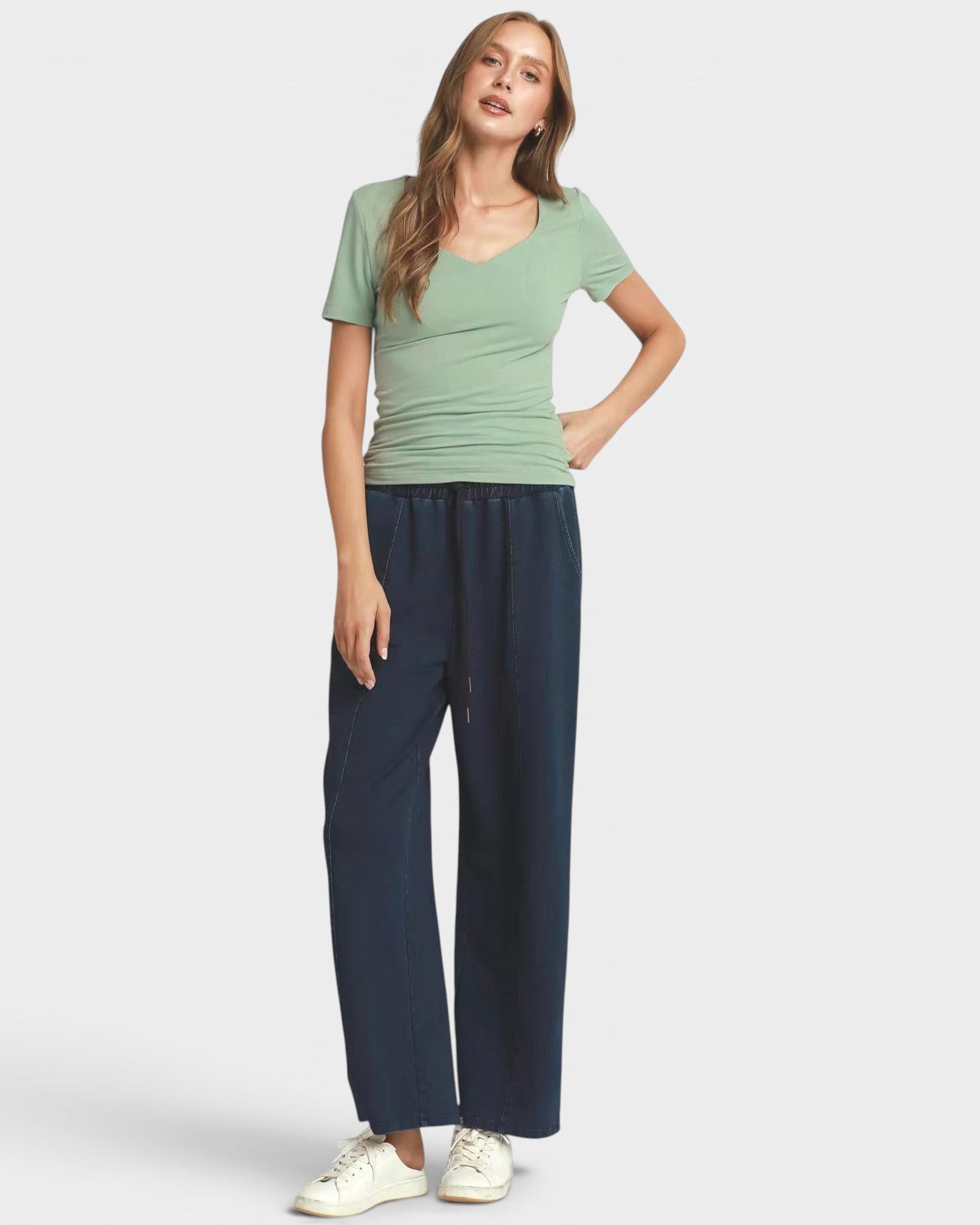 Woman wearing a green t-shirt against a plain background