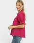 Woman wearing a pink blouse and blue jeans on a white background