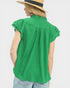 Person wearing a green sleeveless top and straw hat on a white background
