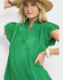 Woman wearing a green dress and straw hat on a white background