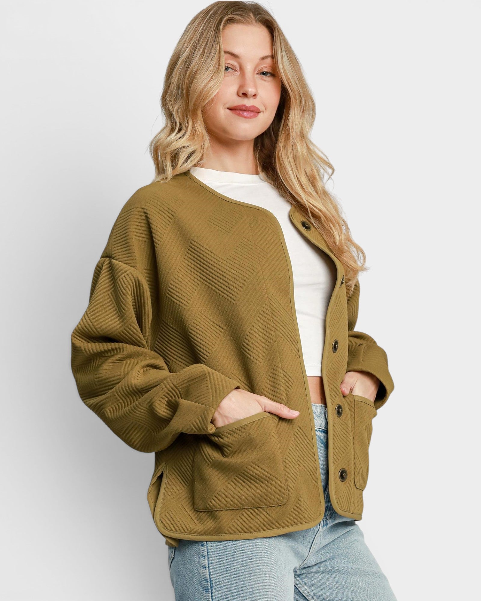 Woman wearing a green jacket against a white background