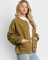 Woman wearing a green jacket against a white background