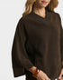 Brown sweater worn by a person on a white background