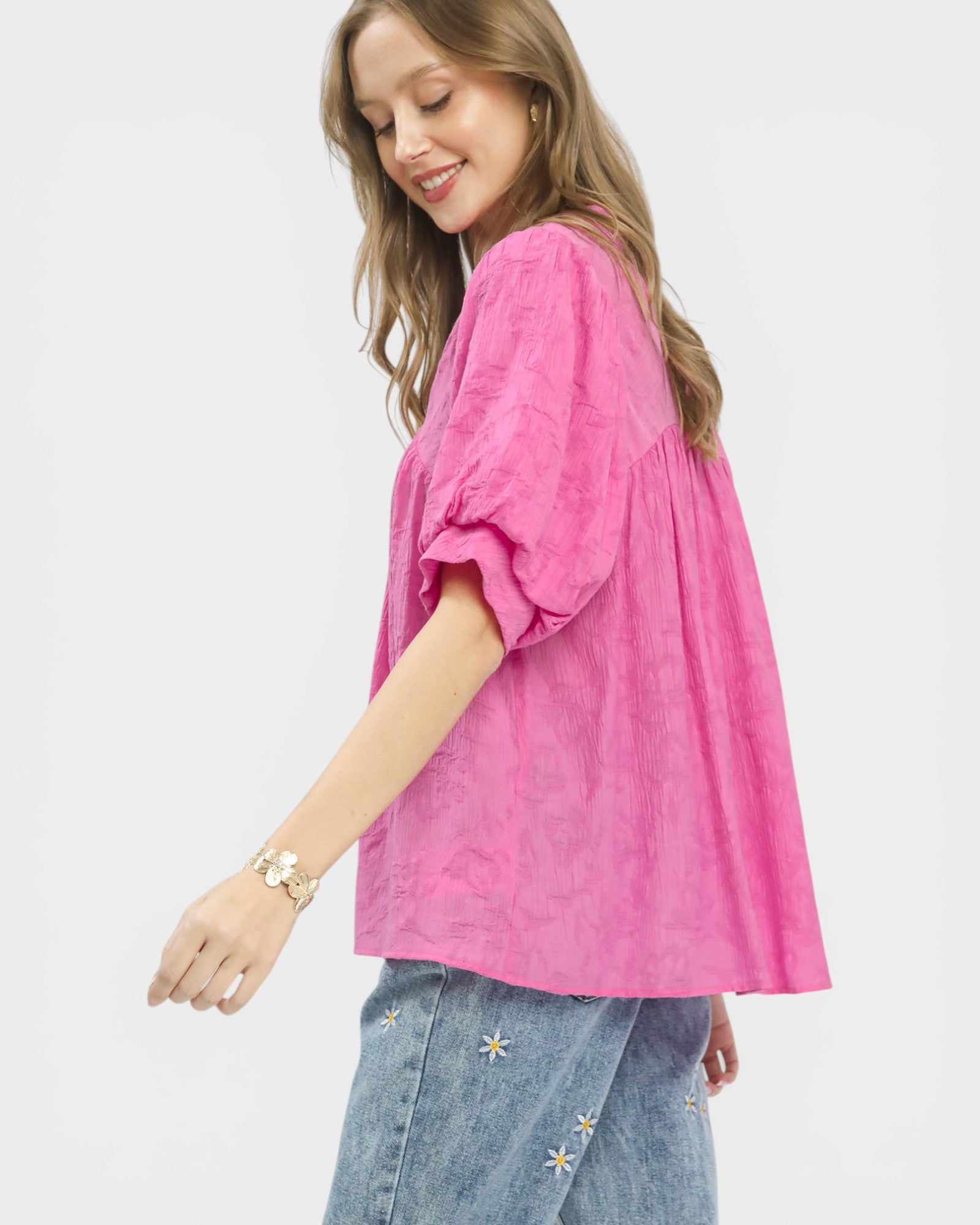 Woman wearing a pink blouse with a white background