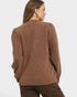 Woman wearing a brown sweater on a white background