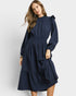 Woman wearing a navy blue dress with long sleeves on a white background