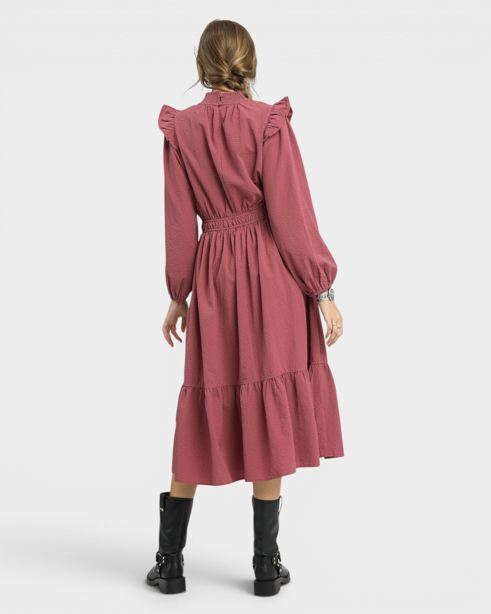Pink dress worn by a person on a white background