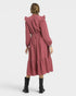 Pink dress worn by a person on a white background